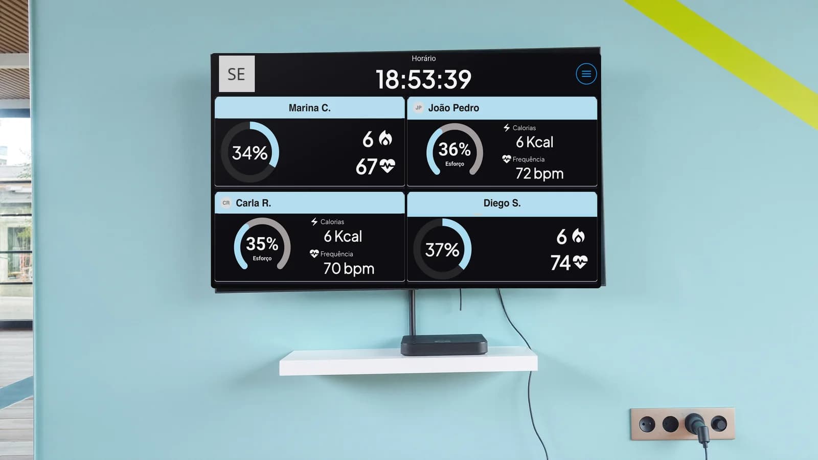 Wall TV in a gym showing Vektor Pulse, with the receiver on the shelf below
